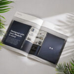 A photo of a magazine double page spread for Symphony group. IT features a large image of a kitchen with pocket doors and a hidden bar. Titled Designed with your lifestyle in mind