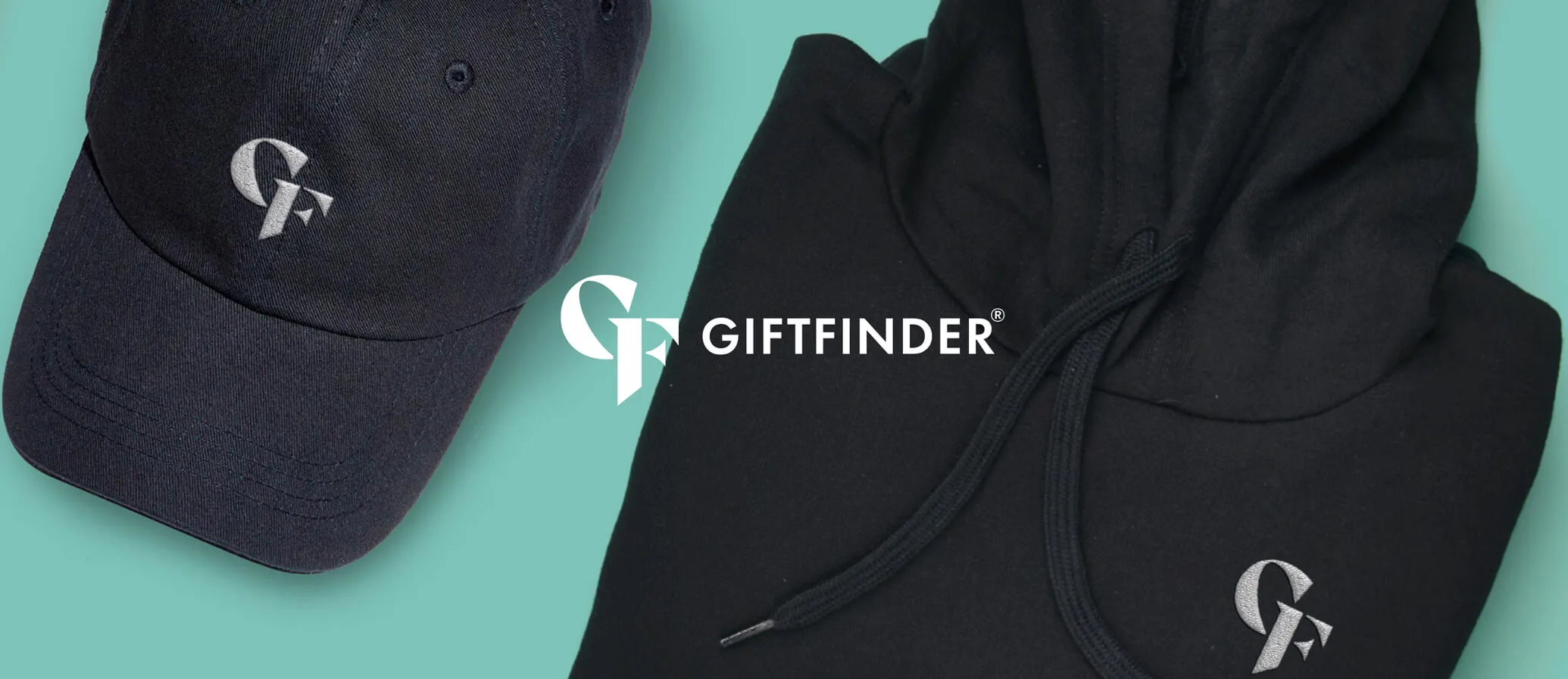 Two pieces of Giftfinder, brandied clothing (cap and hoodie) sat on a blue background